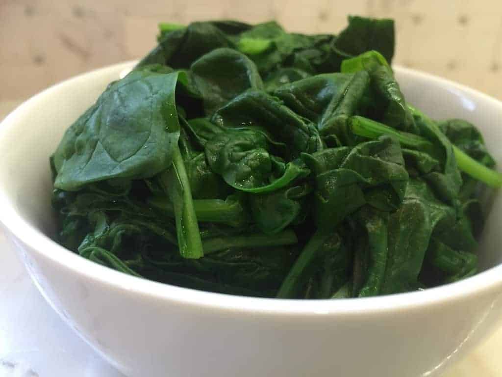 Steamed Spinach in a white bowl 
