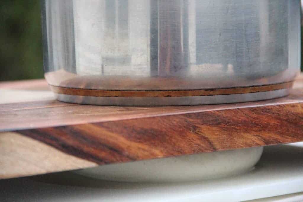 pressing curdled milk to remove excess moisture 