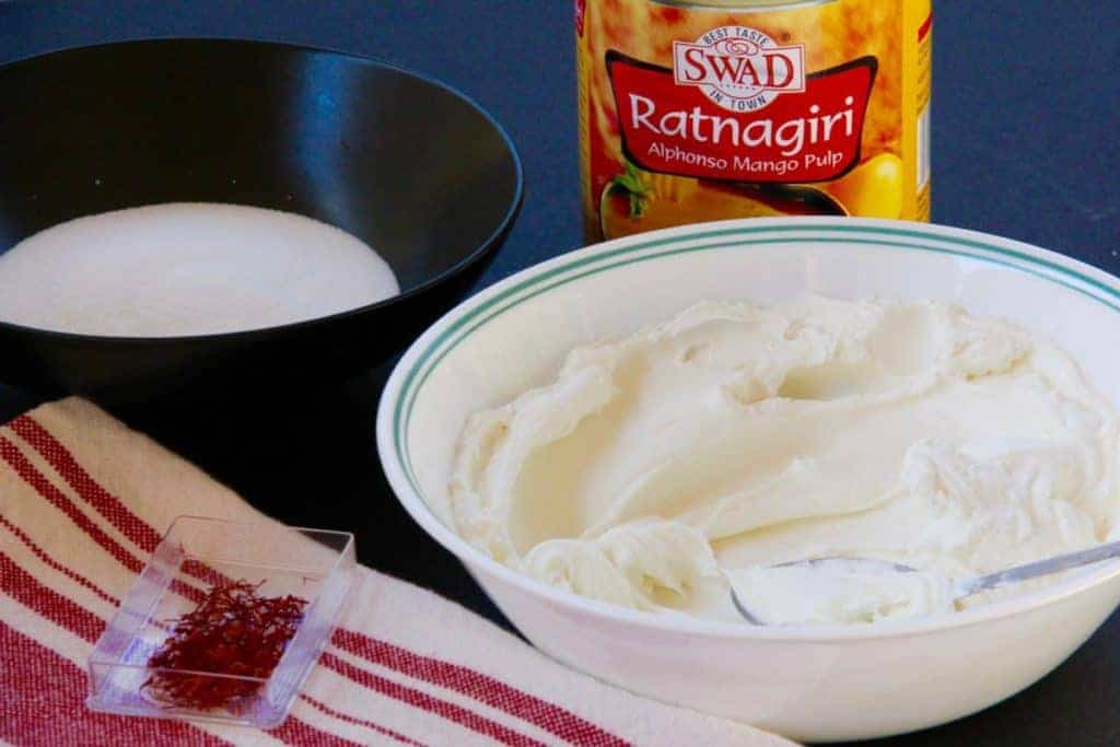 ingredients for shrikhand - mango pulp, strained yogurt, saffron and sugar