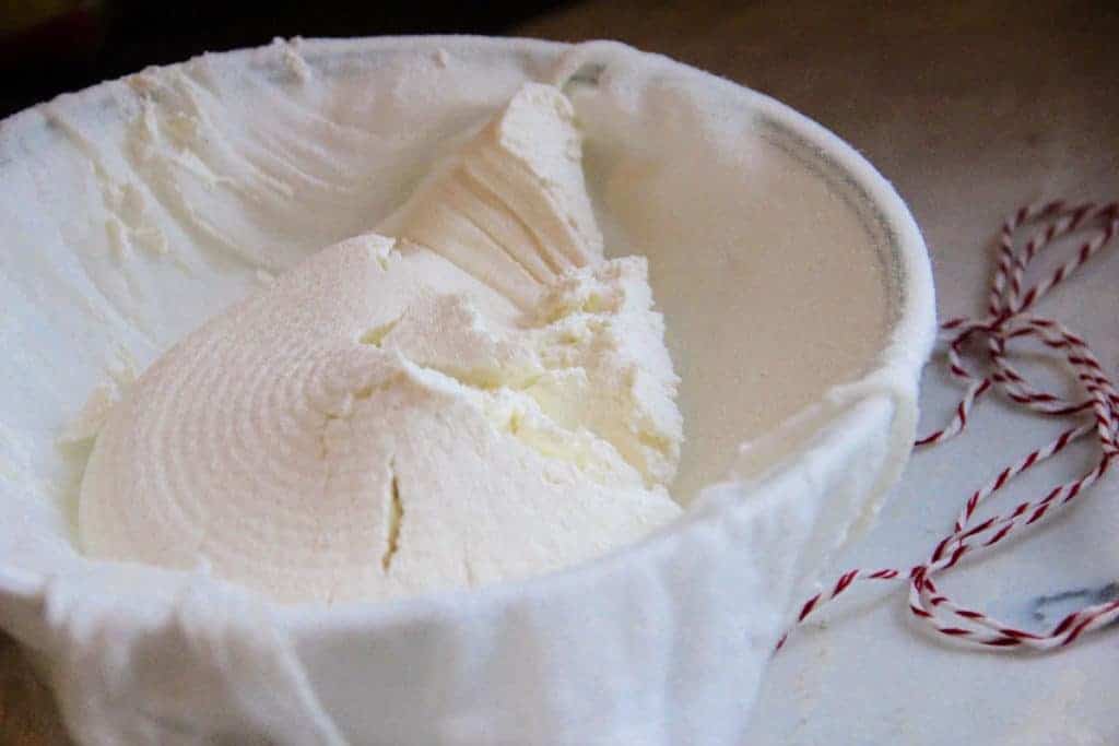 strained yogurt in a cheesecloth 