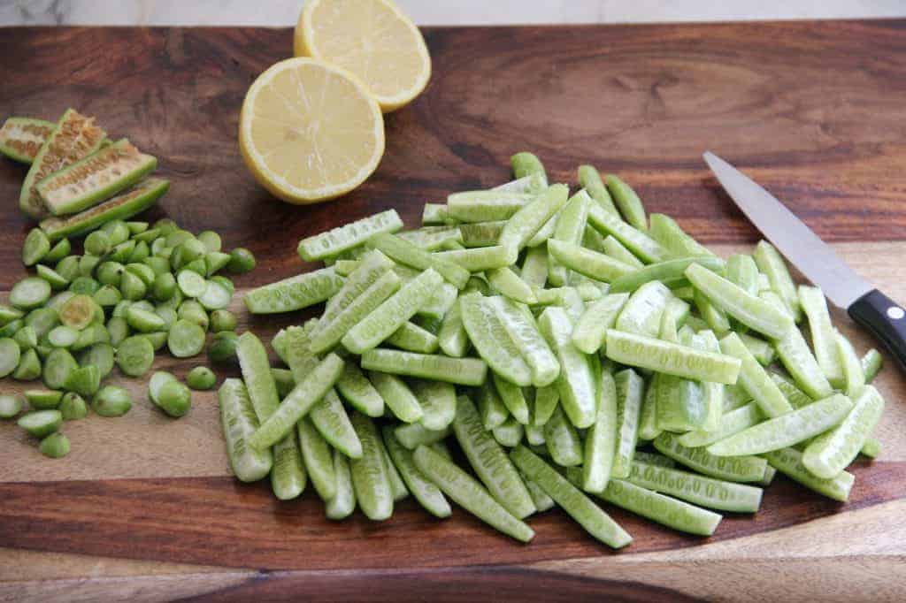 Cut tondli and lemon on a wooden cutting board 