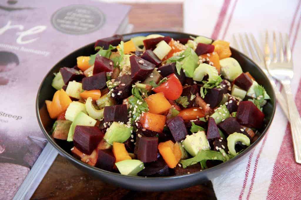 Beet salad served in a black bowl