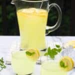 2 glasses and a large pitcher of lemonade