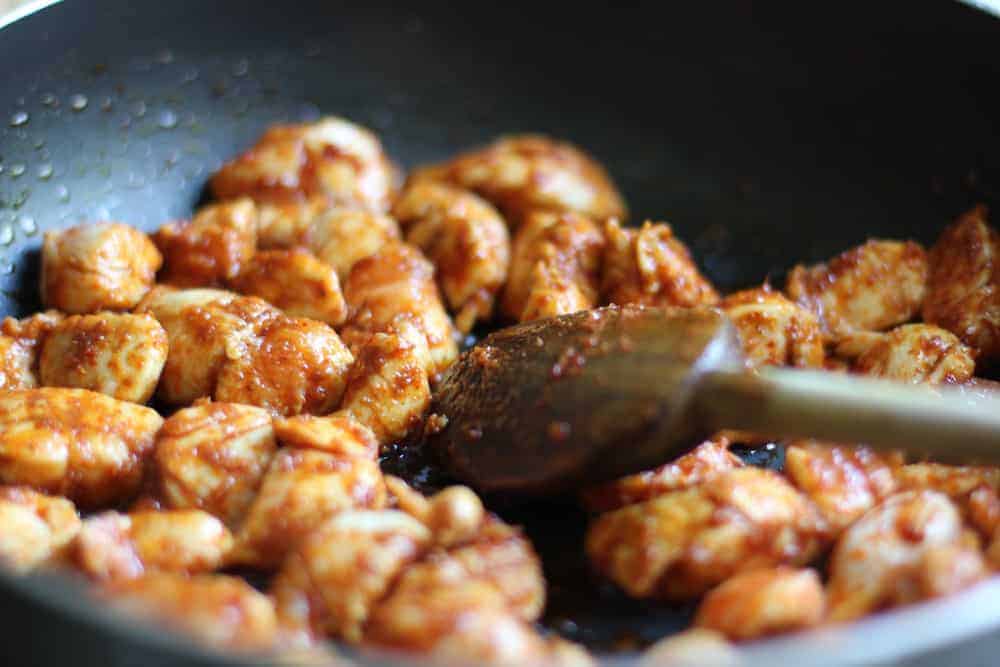 Sautéing chicken with curry paste 