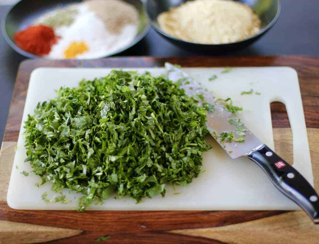 chopped cilantro on cutting board with knife