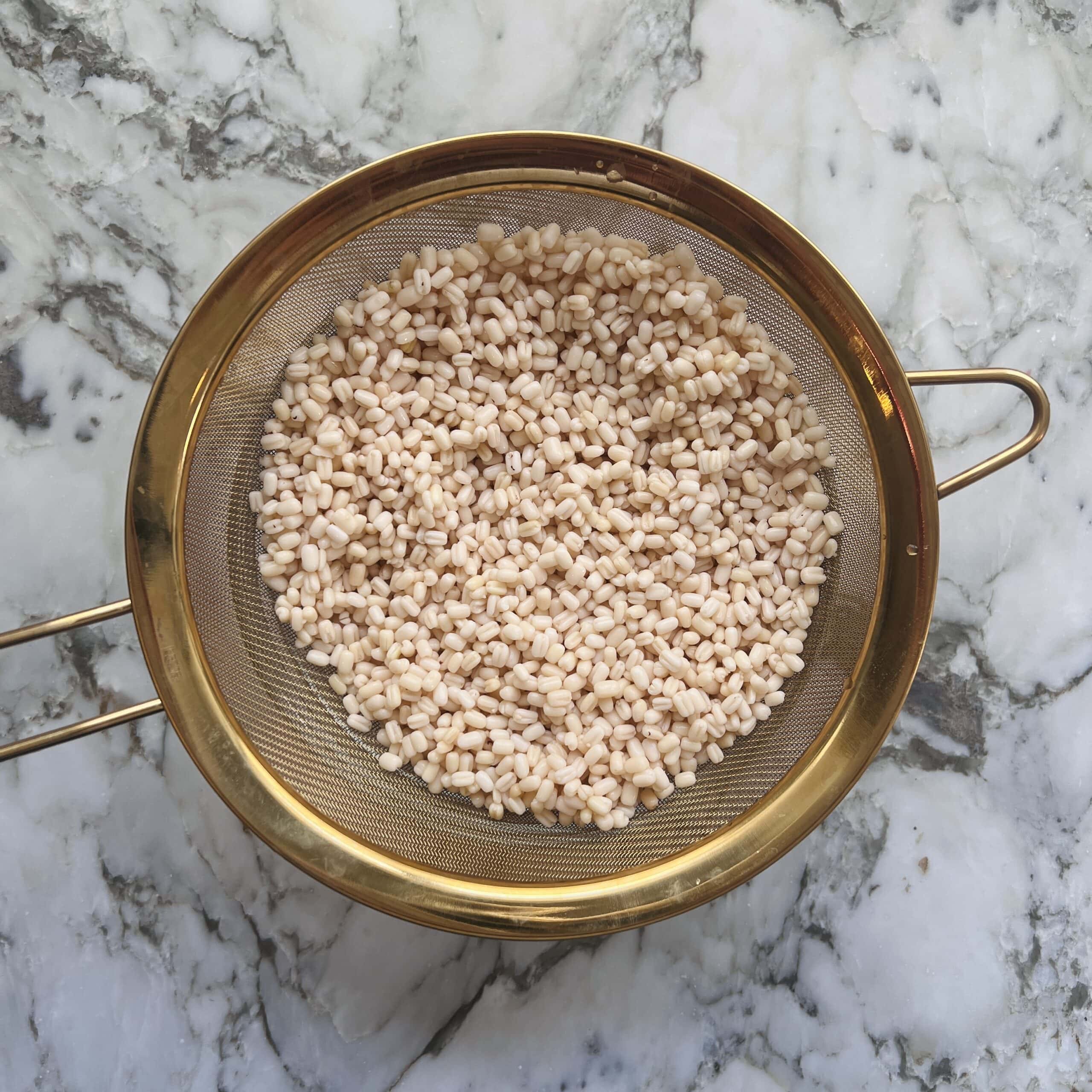 soaked lentils in a strainer