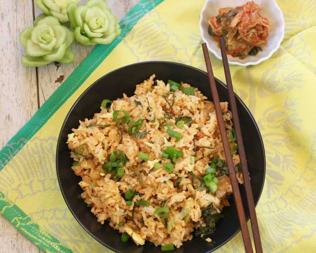 Kimchi Fried Rice served in black bowl with chop sticks