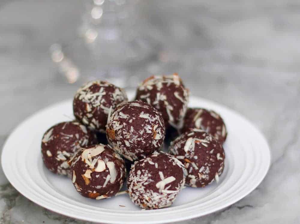 quinoa almond date energy bites in a white plate. 