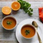 citrusy lentil soup served in 2 white bowls