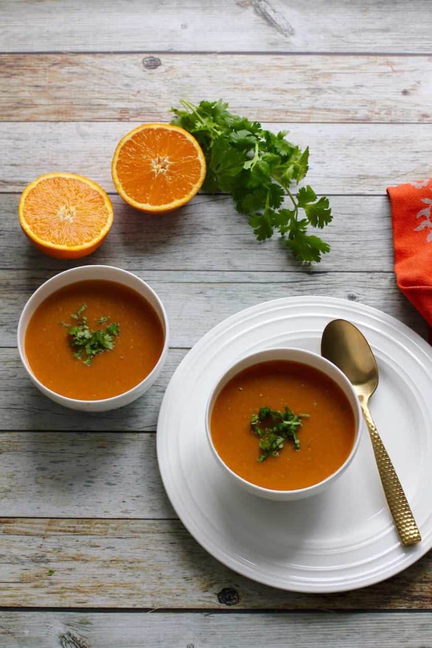 citrusy lentil soup served in 2 white bowls 