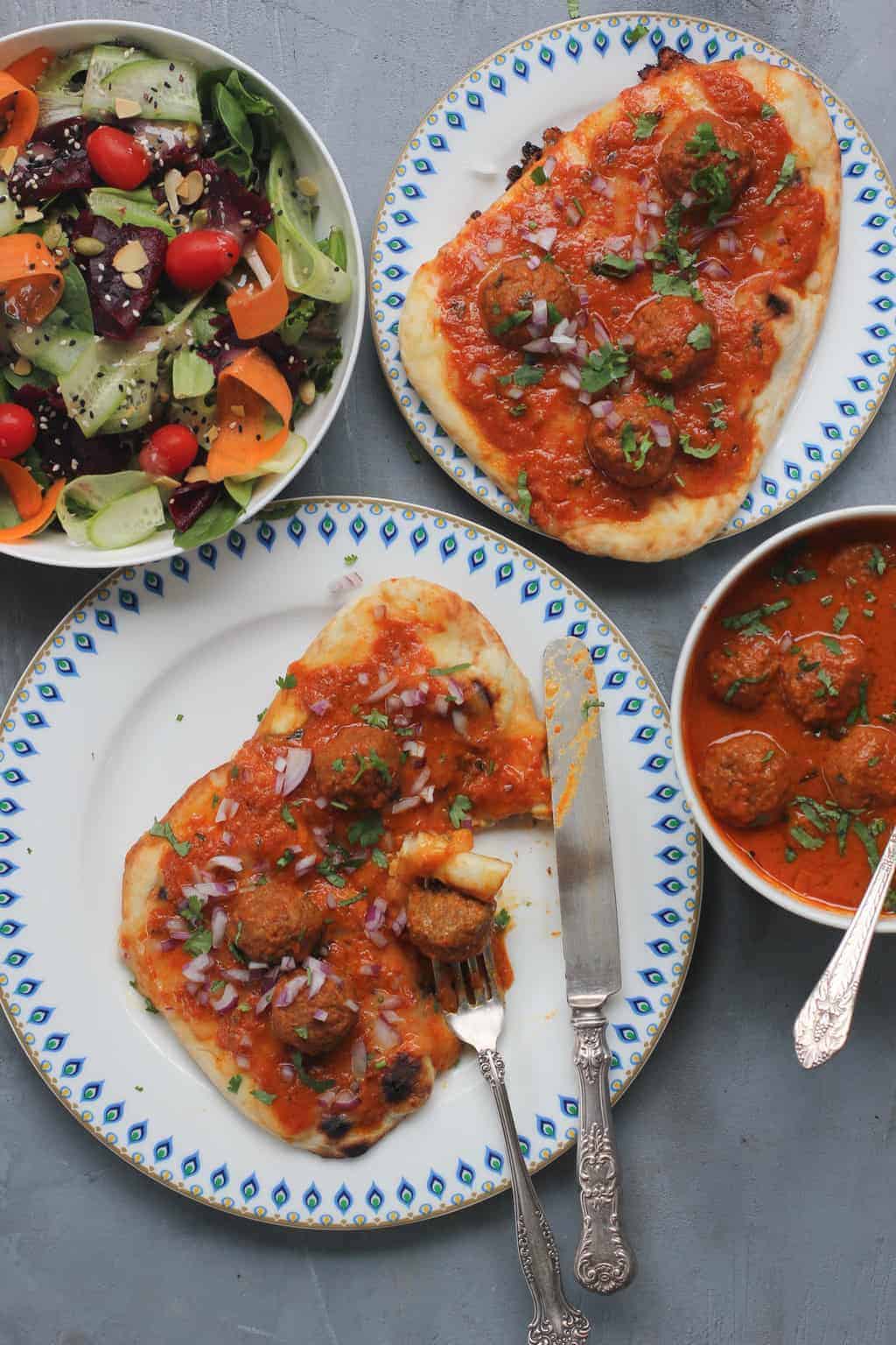 malai kofta served as a pizza over naan and a mixed greens salad.