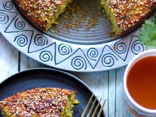 Piece of handvo in a plate with tea