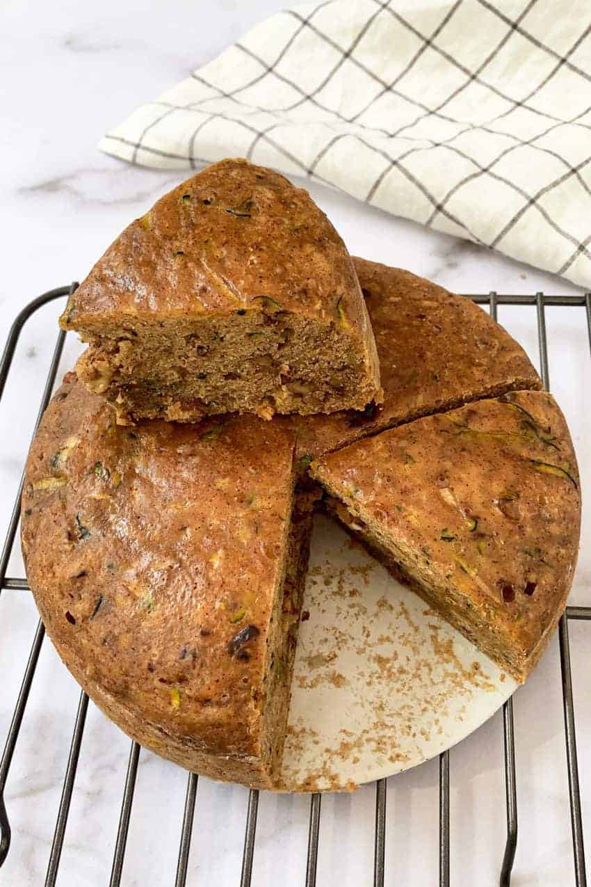 zucchini bread with slice sitting on top of the bread