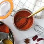 Garam Masala in a glass canister next to the spice box