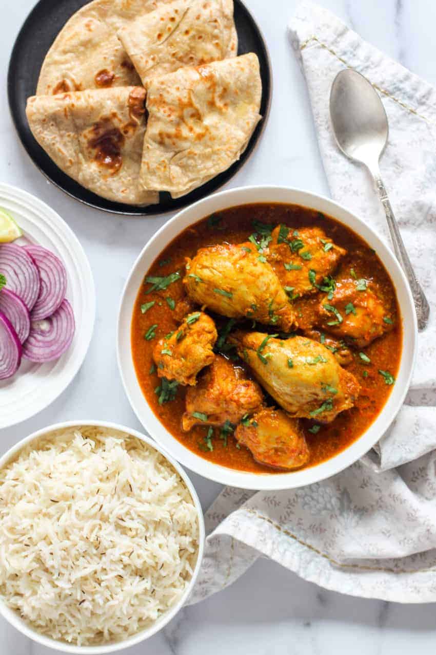 Chicken Curry in a bowl with rice and chapatis