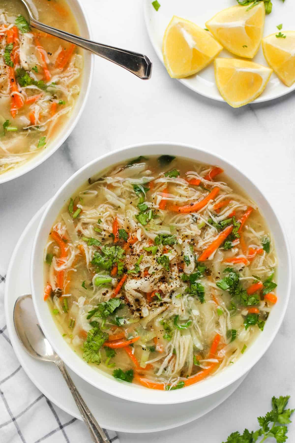 chicken cilantro soup served in a white bowl