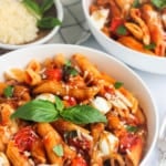 pasta caprese in a white bowl