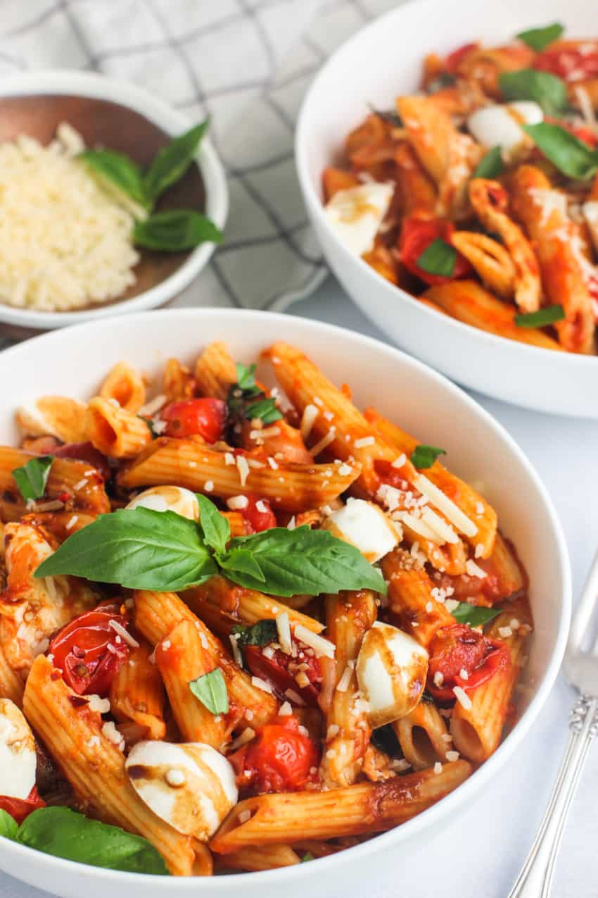 pasta caprese in a white bowl