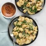 Spinach Artichoke Mac and Cheese pasta served in a black plates