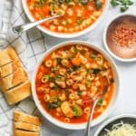 pasta fagioli soup served with sliced baguette