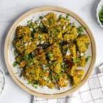 Muthiya garnished with cilantro and freshly grated coconut.