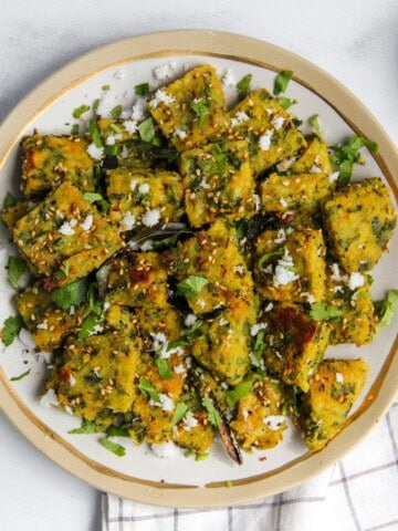 Muthiya garnished with cilantro and freshly grated coconut.
