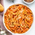 pasta with tomato cream sauce served in a white bowl