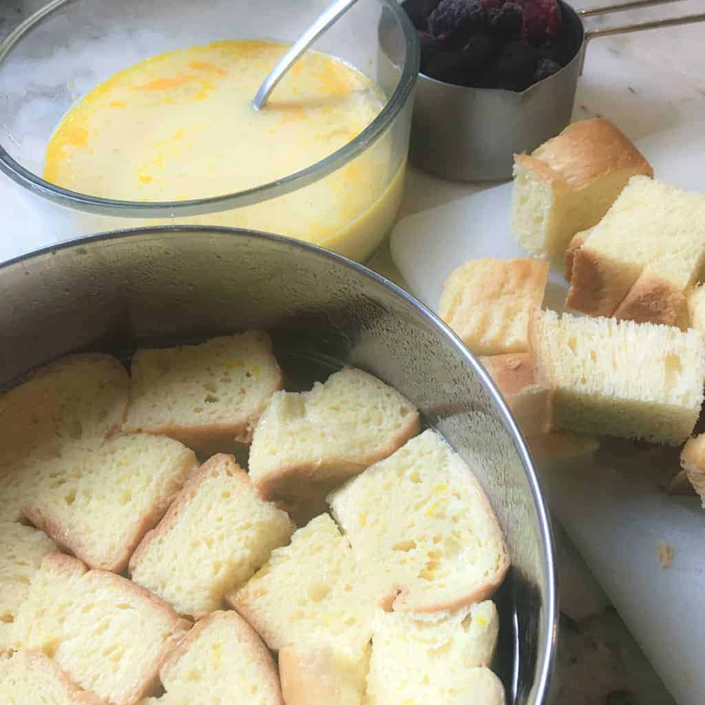 layering bread in a steel pan 