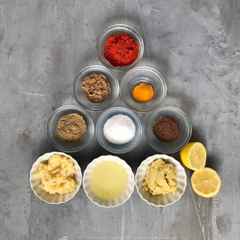 Bowls of spices lines up in a triangle shape