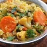 Copper Bowl with vegetable & lentil khichdi , roasted papadums on the side.