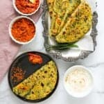 Kale parathas served with yogurt and chutney