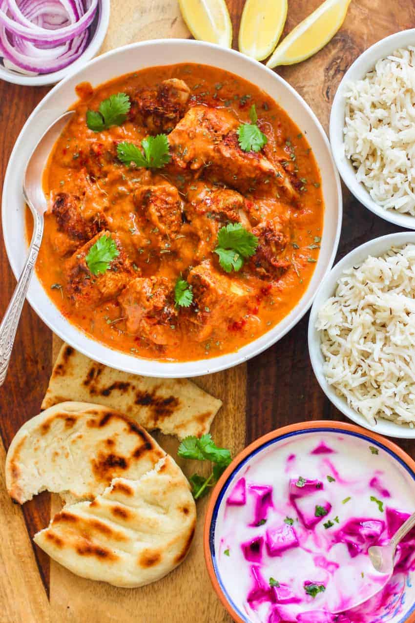 Chicken Tikka masala served with rice, naan and raita