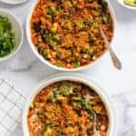 Chicken enchilada quinoa served in 2 white bowls.