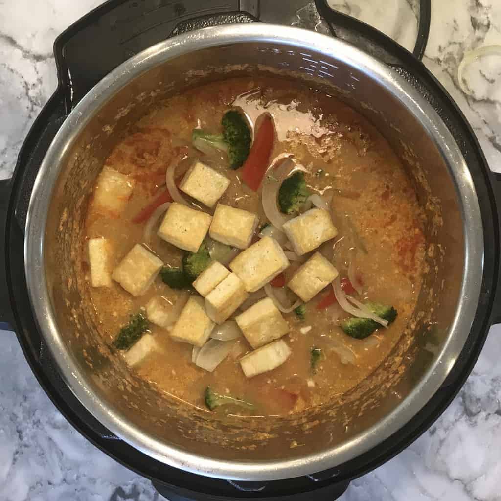 Instant Pot with added sauteed veggies and tofu to the cooked noodles