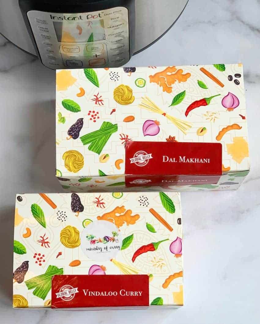 Daal Makhani and Vindaloo pantry kits placed in front of Instant Pot