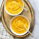 mango shrikhand served in 2 white bowls