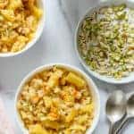Pineapple Sheera served in 2 white bowls with sliced nuts on the side