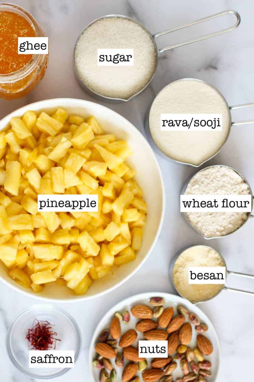 cut pineapples in a bowl with all the other ingredients in measuring cups