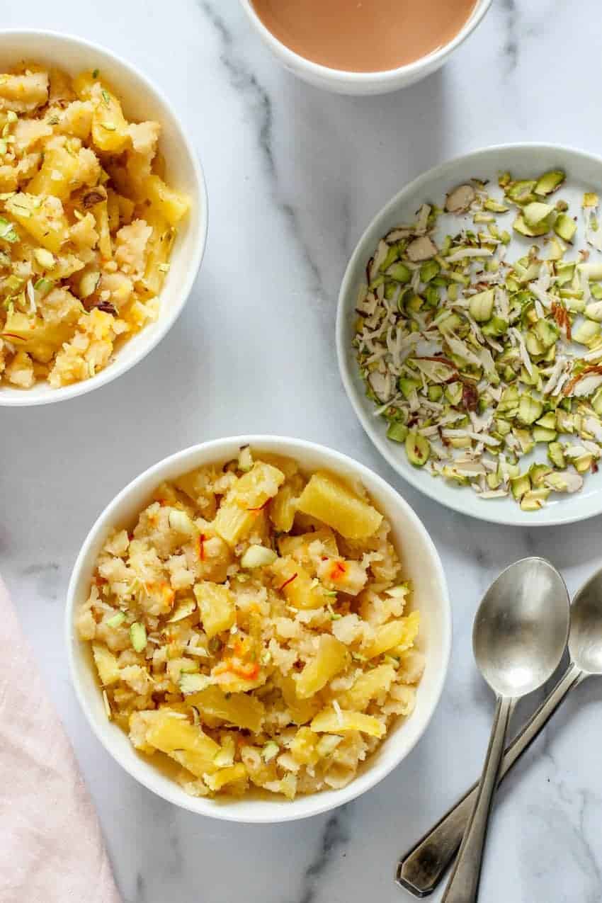 Pineapple Sheera served in 2 white bowls with sliced nuts on the side