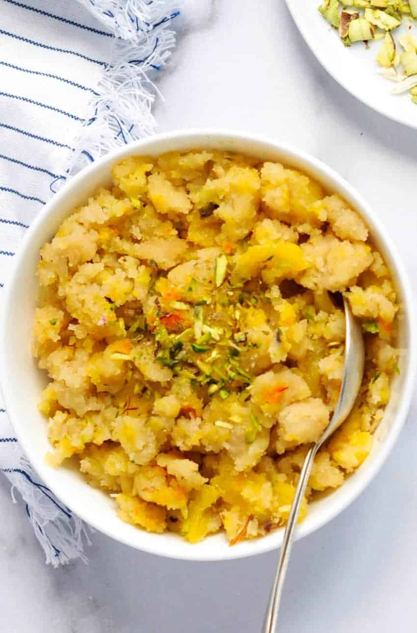 Pineapple Sheera in a white bowl garnished with pistachios 