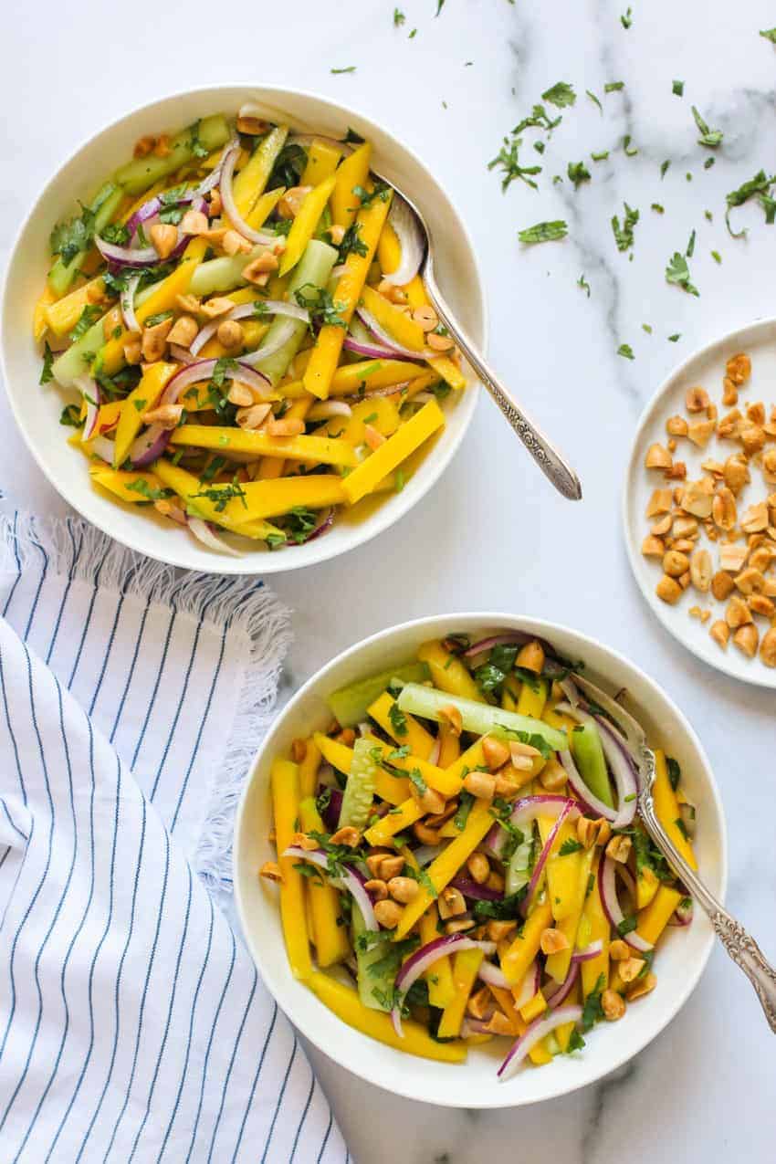 2 white bowls of mango salad