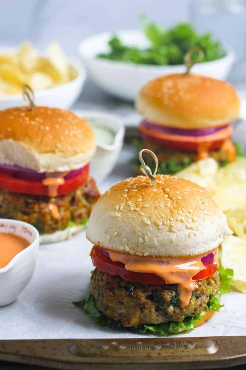3 chicken burgers with sriracha mayo on the side 