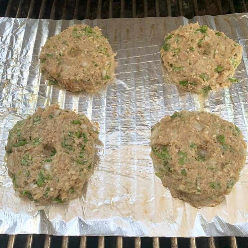 burger patties on grill 
