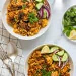 cauliflower rice chicken biryani in 2 white bowls