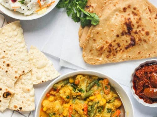Veg Kurma served with parathas, rice and papad