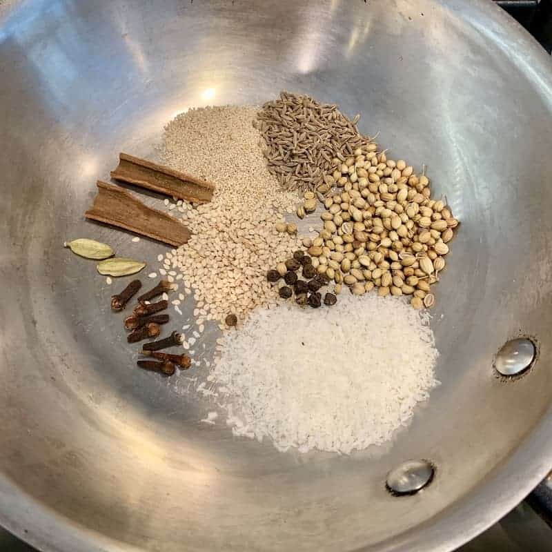 whole spices in a pan 
