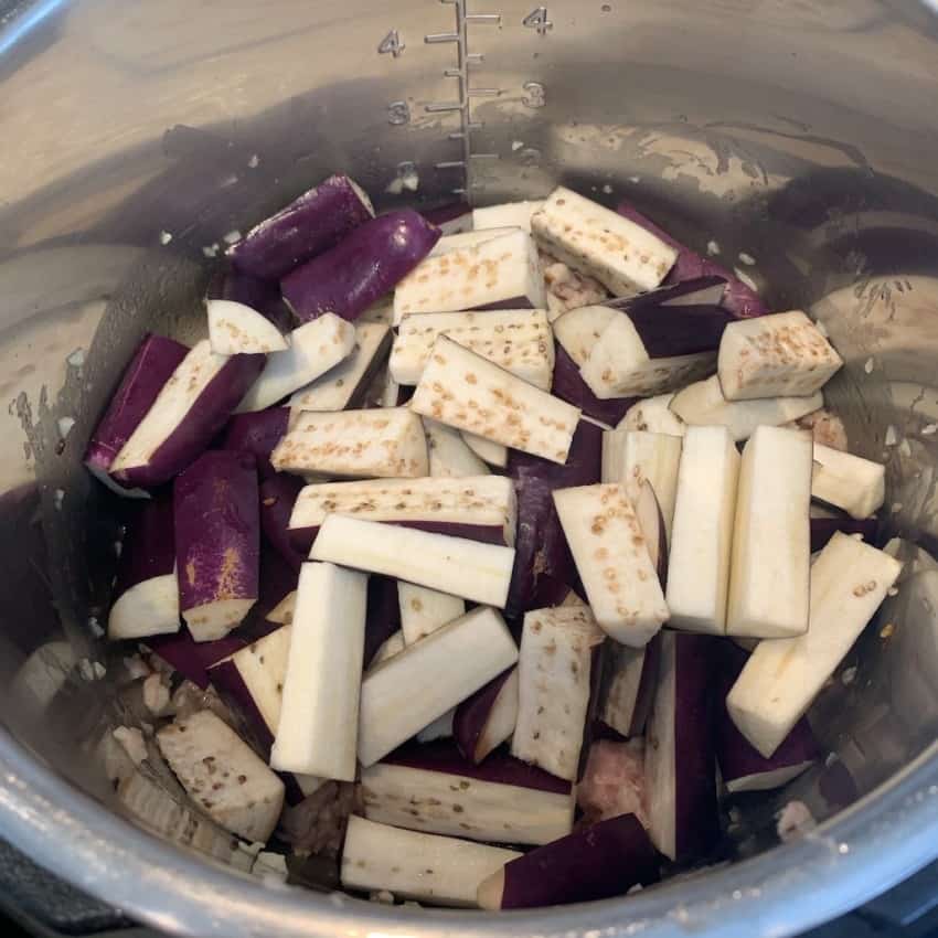 Eggplant wedges added over minced chicken 