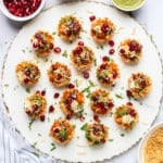 Aloo Chaat served on a marble board with garnishes on the side