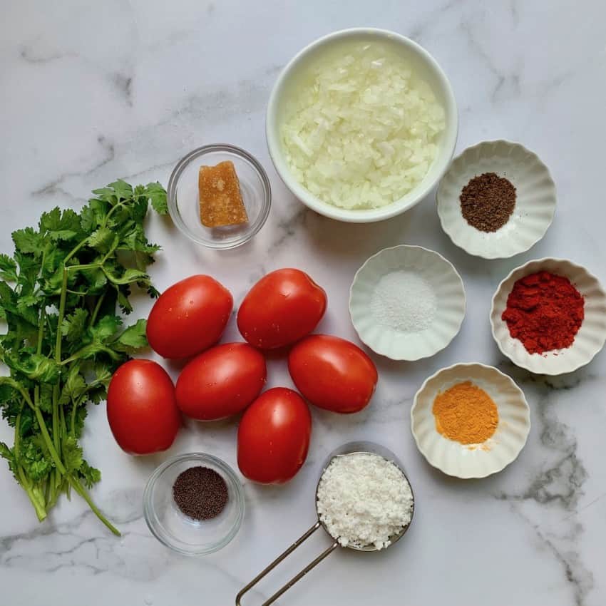 Ingredients for stuffed tomatoes on a white board 