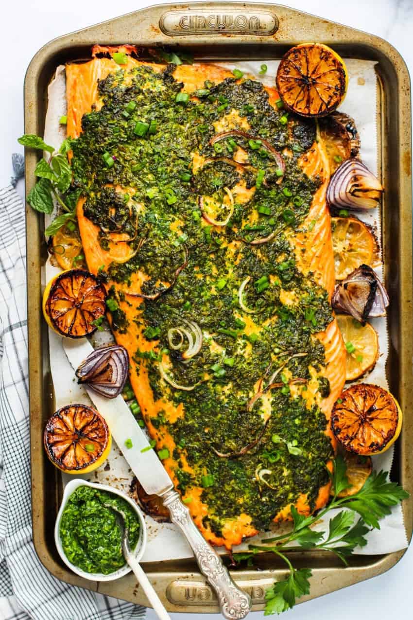 Baked salmon with green marinade on a tray 